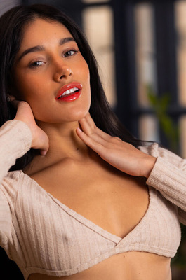 Carolina Guerrero Sheds A Knit Top On A Wood Table In A Sunlit Loft - 00