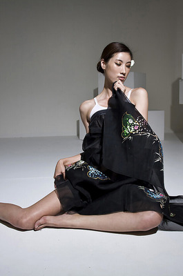 Eunkyung Oh Slips Out Of A Black Butterfly Gown In A White Studio - 02