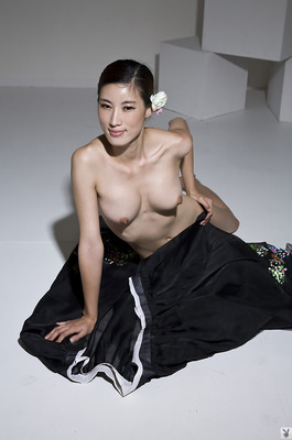 Eunkyung Oh Slips Out Of A Black Butterfly Gown In A White Studio - 11